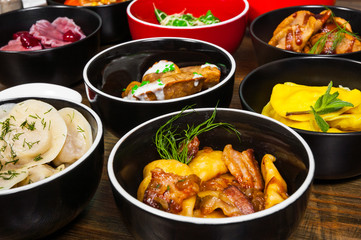 Set of different dumplings and ravioli on a wooden table
