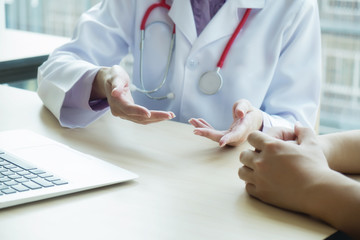 Doctor and patient are discussing something, just hands at the table.