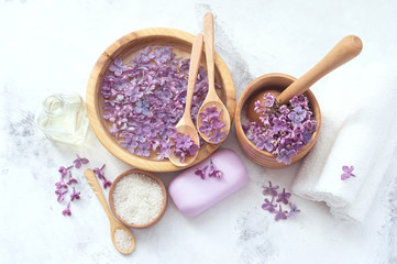 Fototapeta na wymiar Massage and spa products with lilac flowers
