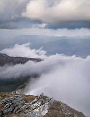 Mountain valley in the clouds. Natural summer landscape