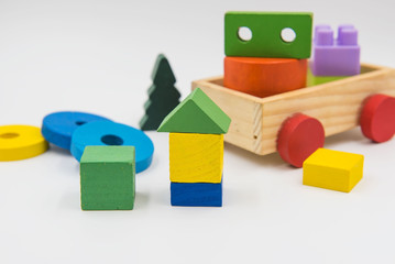 Children's toys are made of colorful wood on a white background.