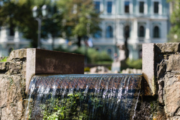 Riga. Latvia. The urban landscape with a waterfall and sculpture.