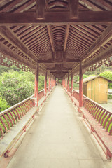 Fototapeta premium long corridor of Chinese traditional architecture in a park,shot in city of China.