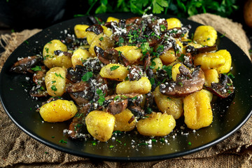 Home made potato gnocchi with mushrooms, chopped parsley and parmesan cheese