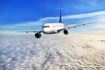 Fototapeta na wymiar Passengers airplane flying above clouds