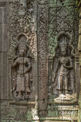 Khmer devata guardian shown in stone in Ta Prohm temple, in Angkor, Siem Reap, Cambodia.