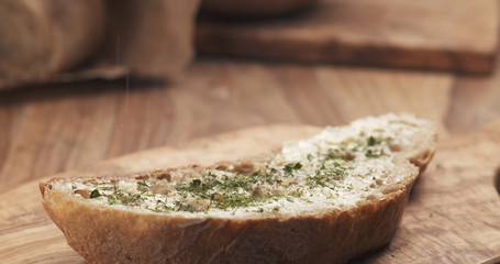 salt falling on rustic bread with butter, 4k photo