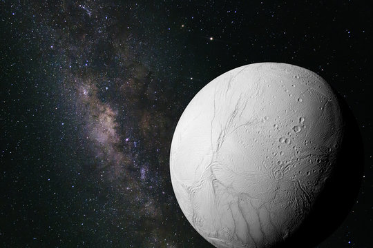 Enceladus, moon of the planet Saturn in front of the Milky Way galaxy