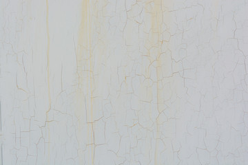 Bright wall with cracks and rusty streaks