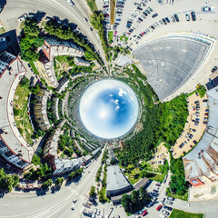 Aerial city view with crossroads and roads, houses, buildings, parks and parking lots, bridges. Helicopter drone shot. Wide Panoramic image.