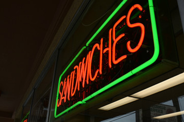 red and green neon signs in store windows