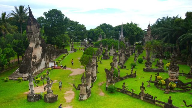 Vientiane, Laos. Famous Buddha park in Vientiane, Laos with numerous Buddha statues. Time-lapse during the cloudy day in summer