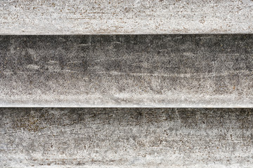 Old concrete texture with scuffs, chips and scratches predominantly in gray colors