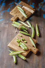 Lady Fingers or Okra over wooden table background. Top view