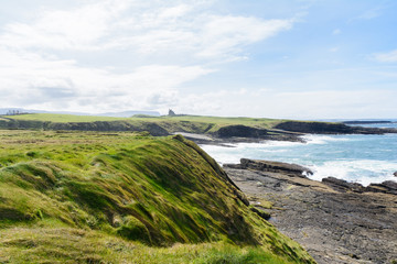 beautiful landscape of Irish coast with classiebawn castle at background