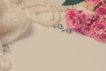 Female accessories frame with fresh roses bouquet and copy space, retro toned
