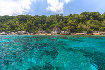 Fototapeta premium Tropical island beach and clear blue lagoon water with blue sky at Similan Island, Phang Nga Province, South of Thailand 
