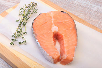 fresh raw salmon with spices on wooden cutting board. ready for cookin