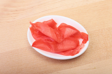 plate with Japanese pickled ginge on wood background.