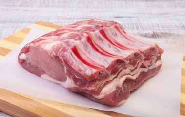 Raw pork chops, spices on cutting board. Ready for cooking.