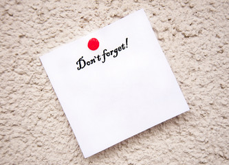 white notepad on the wall , With the words Do not forget