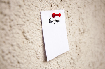 white notepad on the wall , With the words Do not forget