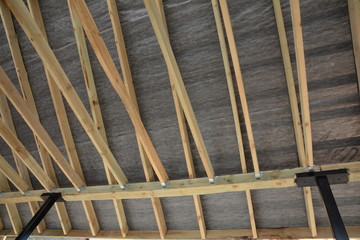 Roof contractor repair. Wooden roof construction. house building. Installation of wooden beams at construction the roof truss system of the house.