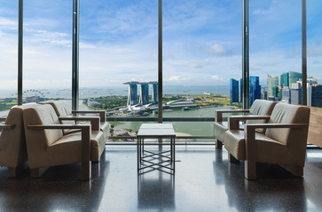 Luxury hotel lounge with windows overlooking city in Singapore. Marina bay view thought the window in Singapore.