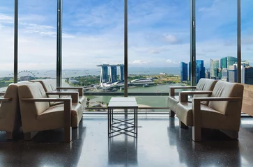 Poster Luxury hotel lounge with windows overlooking city in Singapore. Marina bay view thought the window in Singapore. © ake1150