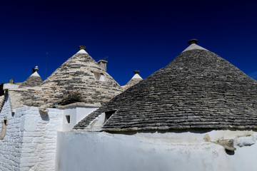 Fototapeta na wymiar Traditional white trulli buildings