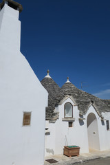 Fototapeta na wymiar Traditional white trulli buildings
