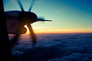 Naklejka na ściany i meble airplane sunset Flying in the sky, evening flight