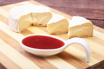 Cheese with white mold. Camembert or brie type with Cranberry sauce.. Healthy breakfast.