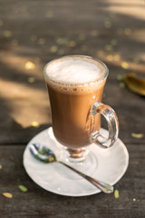 Mag of hot cocoa and foam on wooden table