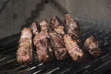 beef steak cooking on an open flame grill