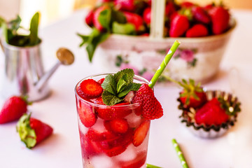 Homemade strawberry lemonade with mint on a white background