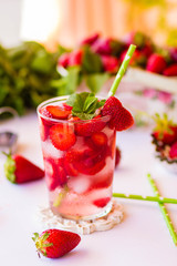Homemade strawberry lemonade with mint on a white background