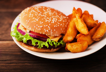 Delicious burger with beef, tomato, cheese, onion