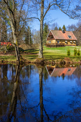 Fototapeta na wymiar House with garden by a river