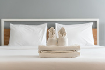 folded white towel in a hotel bedroom