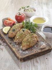 Chicken fillet in marinade on a wooden board. 