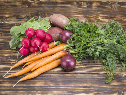 Fresh vegetables on a wooden background. 