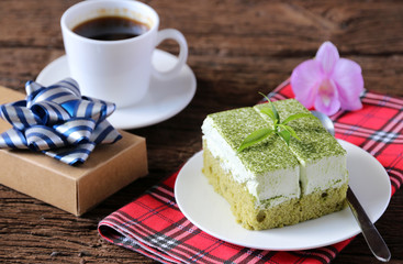 Green tea cake and hot coffee on the table