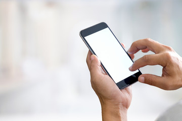 Man holding smart phone with blurred background.  For Graphic display montage.