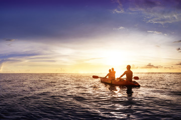 Family with child swims on kayak