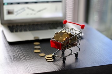 Red Shopping Cart in front of Laptop