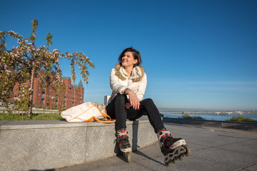 Cheerful girl rests after roller skating