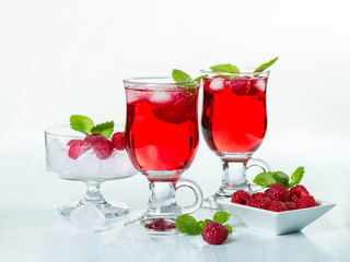 Alcohol cocktail with raspberries and mint
