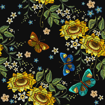 Embroidery sunflowers and butterflies seamless pattern. Classical embroidery blossoming sunflowers and color butterflies seamless background. Template for fashion clothes, t-shirt design