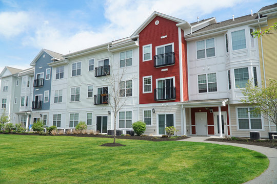 colorful apartment buildings and green front lawn in spring